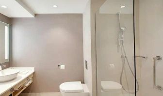 clean and spacious guest bathroom with shower at Hilton Garden Inn Budapest City Centre.