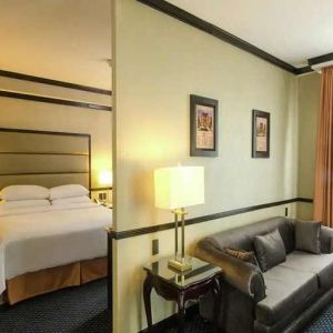 spacious king suite with comfortable lounge area at Hilton Princess San Pedro Sula.