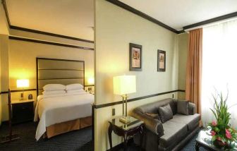 spacious king suite with comfortable lounge area at Hilton Princess San Pedro Sula.