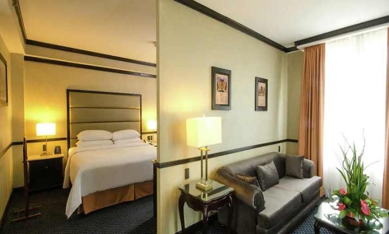 spacious king suite with comfortable lounge area at Hilton Princess San Pedro Sula.