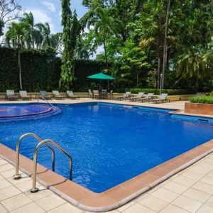 lovely outdoor pool with seating area and sun beds at Hilton Princess San Pedro Sula.