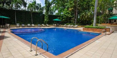 lovely outdoor pool with seating area and sun beds at Hilton Princess San Pedro Sula.