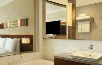 guest bathroom with bath and shower combo at Hilton Chennai.