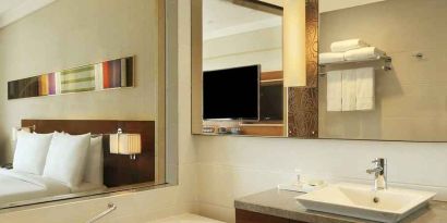 guest bathroom with bath and shower combo at Hilton Chennai.