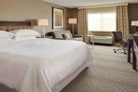 Spacious king suite with TV, business desk, and lounge area at Wyndham Omaha.