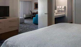 Spacious king suite with TV and lounge area at Sonesta Select Atlanta Norcross I-85.