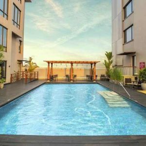 stunning outdoor pool with seating area at Hilton Garden Inn Trivandrum.