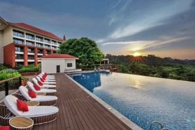 stunning outdoor infinity pool with sun beds at DoubleTree by Hilton Goa - Panaji.