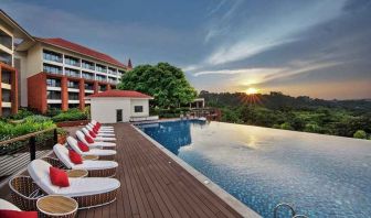 stunning outdoor infinity pool with sun beds at DoubleTree by Hilton Goa - Panaji.