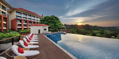 stunning outdoor infinity pool with sun beds at DoubleTree by Hilton Goa - Panaji.