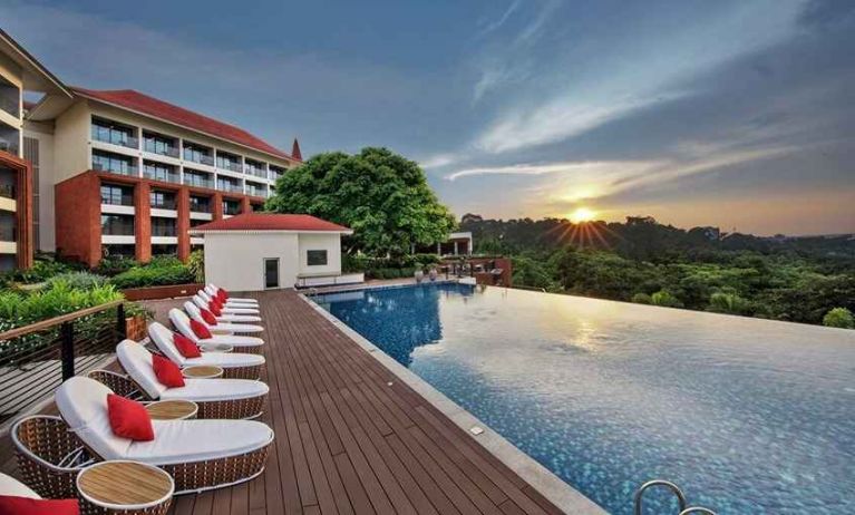 stunning outdoor infinity pool with sun beds at DoubleTree by Hilton Goa - Panaji.