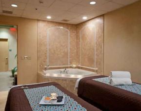 Spa with jacuzzi and massage tables at the Embassy Suite by Hilton Charlotte-Concord- Golf Resort & Spa.