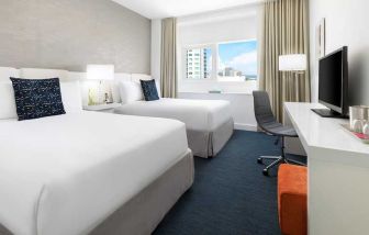 Twin room with desk at the YVE Hotel Miami.