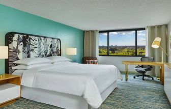 King bedroom with desk at the Sheraton Miami Airport Hotel.