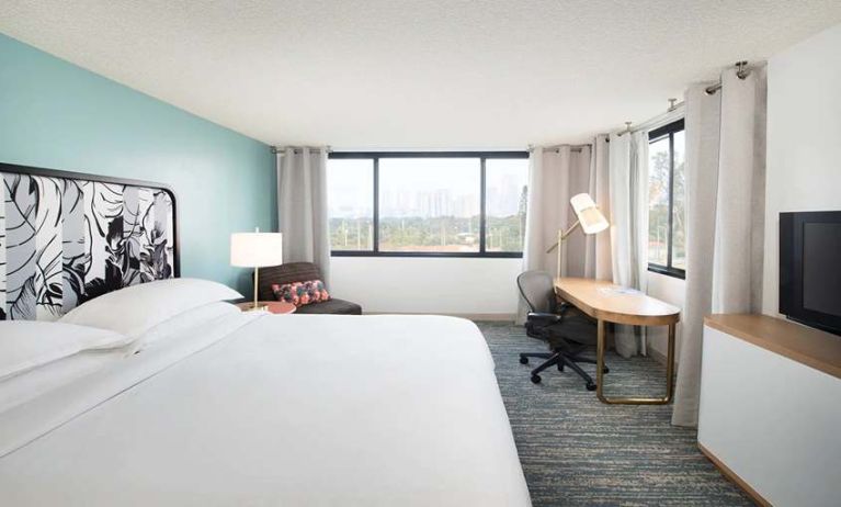 Hotel bedroom with working station and TV screen at the Sheraton Miami Airport Hotel.