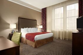 Hotel bedroom with working station at the Embassy Suites by Hilton St. Louis Downtown.