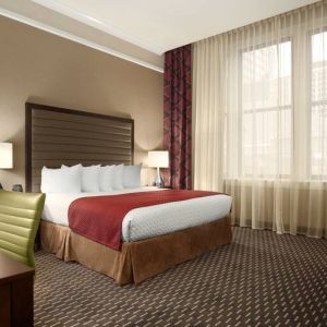 Hotel bedroom with working station at the Embassy Suites by Hilton St. Louis Downtown.