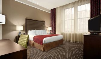 Hotel bedroom with working station at the Embassy Suites by Hilton St. Louis Downtown.