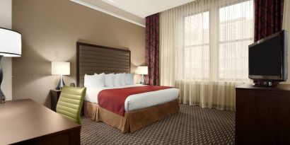 Hotel bedroom with working station at the Embassy Suites by Hilton St. Louis Downtown.