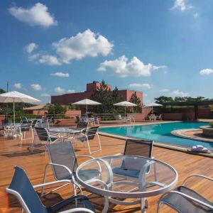 View of outside pool, deck and seating area to sunbathe.