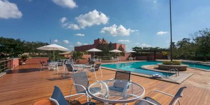 View of outside pool, deck and seating area to sunbathe.