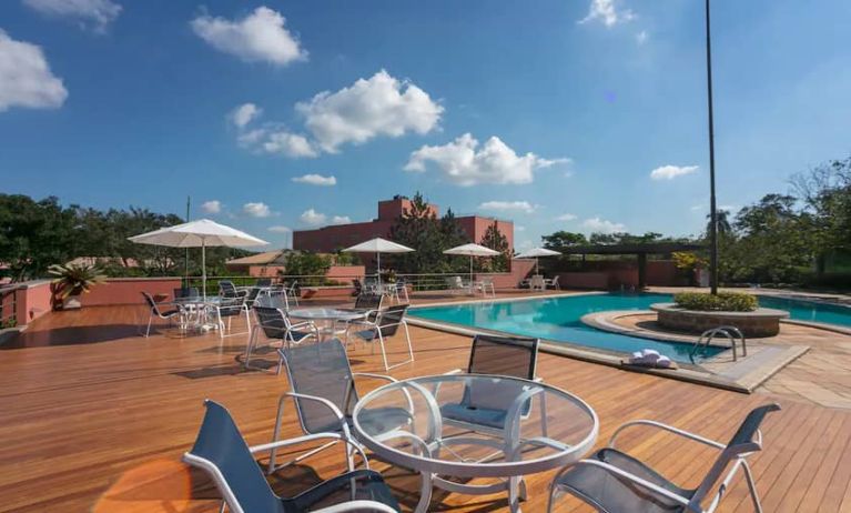 View of outside pool, deck and seating area to sunbathe.