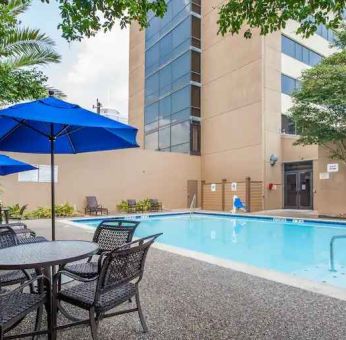 Relaxing outdoor pool area at the Doubletree by Hilton Houston Medical Center Hotel & Suites.