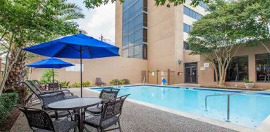 Relaxing outdoor pool area at the Doubletree by Hilton Houston Medical Center Hotel & Suites.