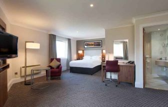 Spacious hotel suite with working station at the Doubletree by Hilton Glasgow Strathclyde.