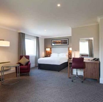 Spacious hotel suite with working station at the Doubletree by Hilton Glasgow Strathclyde.