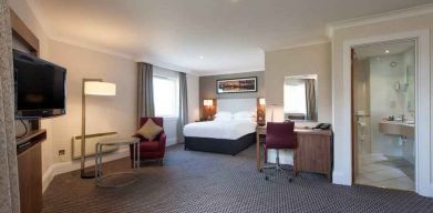 Spacious hotel suite with working station at the Doubletree by Hilton Glasgow Strathclyde.