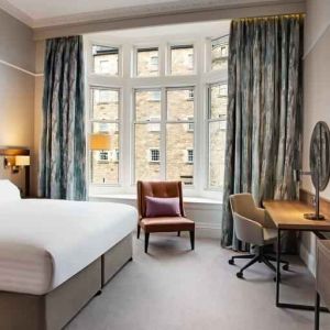 King bedroom with large window at the Hilton Edinburgh Carlton.