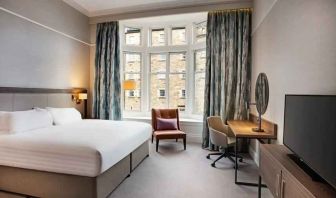 King bedroom with large window at the Hilton Edinburgh Carlton.