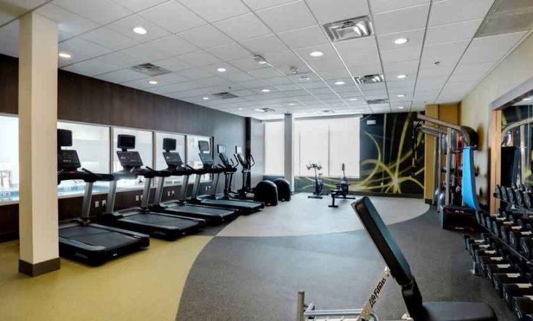 Large fitness room with 3 treadmills, 2 eliptical machines, freeweights, area for stretching and cable machine for resistance training.