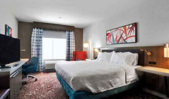 Queen size bed with work desk at Hilton Garden Inn Bel Air.
