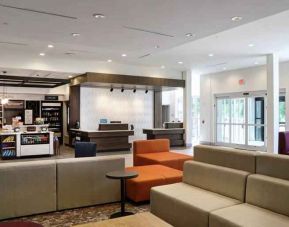 Gray, salmon and purple colored couches decorate the lobby area of the Hilton Garden Inn Bel Air.
