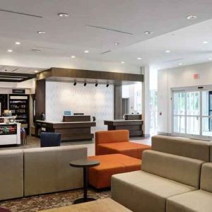 Gray, salmon and purple colored couches decorate the lobby area of the Hilton Garden Inn Bel Air.