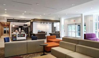 Gray, salmon and purple colored couches decorate the lobby area of the Hilton Garden Inn Bel Air.