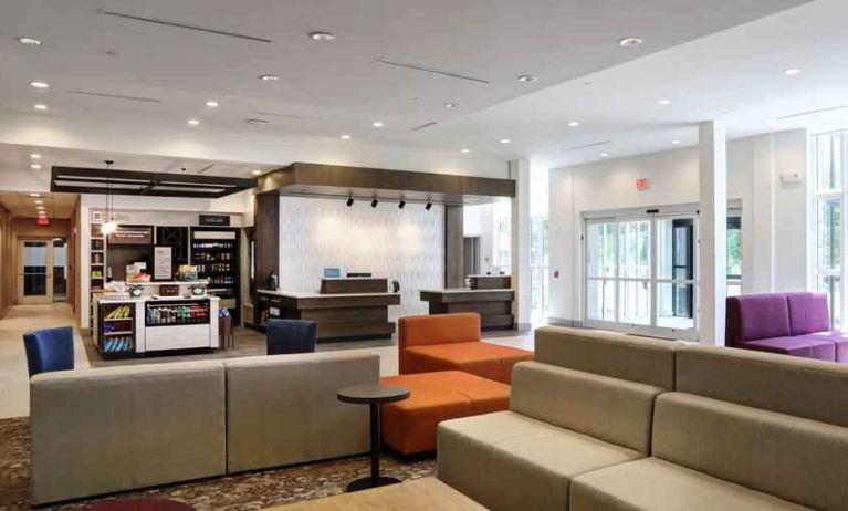 Gray, salmon and purple colored couches decorate the lobby area of the Hilton Garden Inn Bel Air.