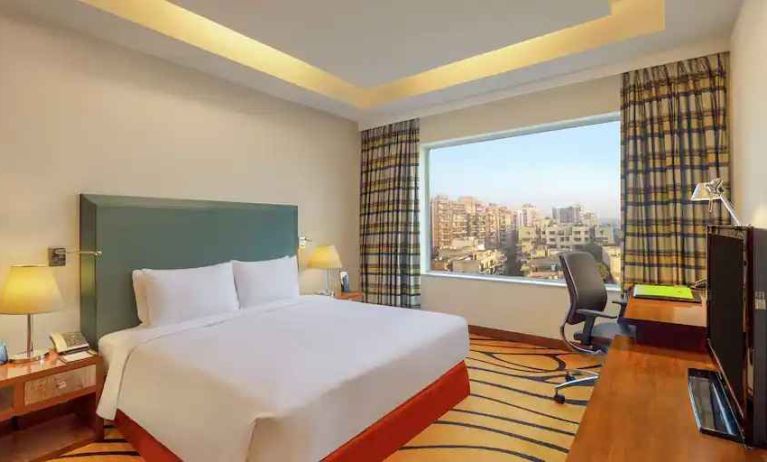 Bright hotel room with desk at the DoubleTree by Hilton Hotel Gurgaon - New Delhi NCR.