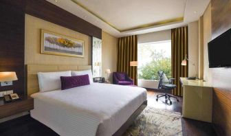 King bedroom with desk at the DoubleTree by Hilton Gurugram Baani Square.