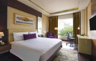 King bedroom with desk at the DoubleTree by Hilton Gurugram Baani Square.