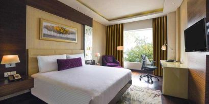 King bedroom with desk at the DoubleTree by Hilton Gurugram Baani Square.