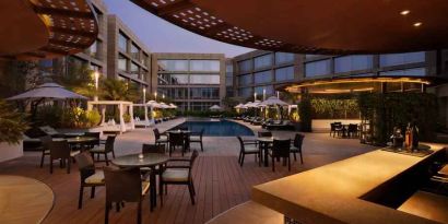 Seating area by the pool perfect as workspace at the Hilton Bangalore Embassy GolfLinks.