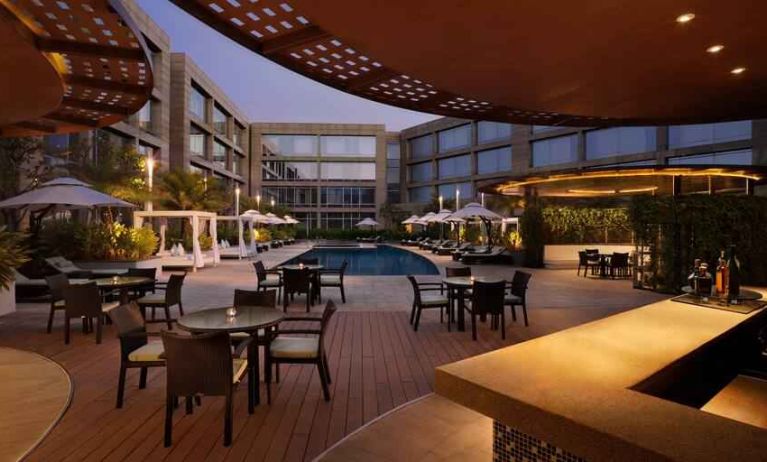 Seating area by the pool perfect as workspace at the Hilton Bangalore Embassy GolfLinks.