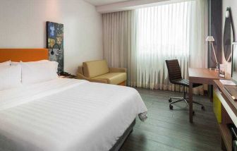 King bedroom with desk at the Hampton by Hilton Cartagena.