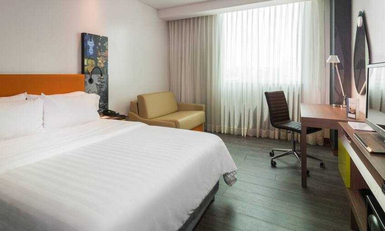 King bedroom with desk at the Hampton by Hilton Cartagena.