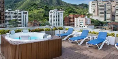 Outdoor terrace with pool at the Hampton by Hilton Cali.