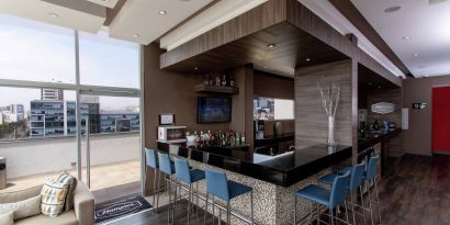 Seating area along the bar at the Hampton by Hilton Lima San Isidro.