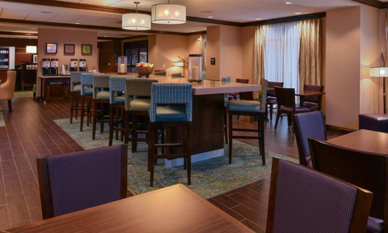 Seating area along the bar at the Hampton Inn Omaha Midtown-Aksarben Area.